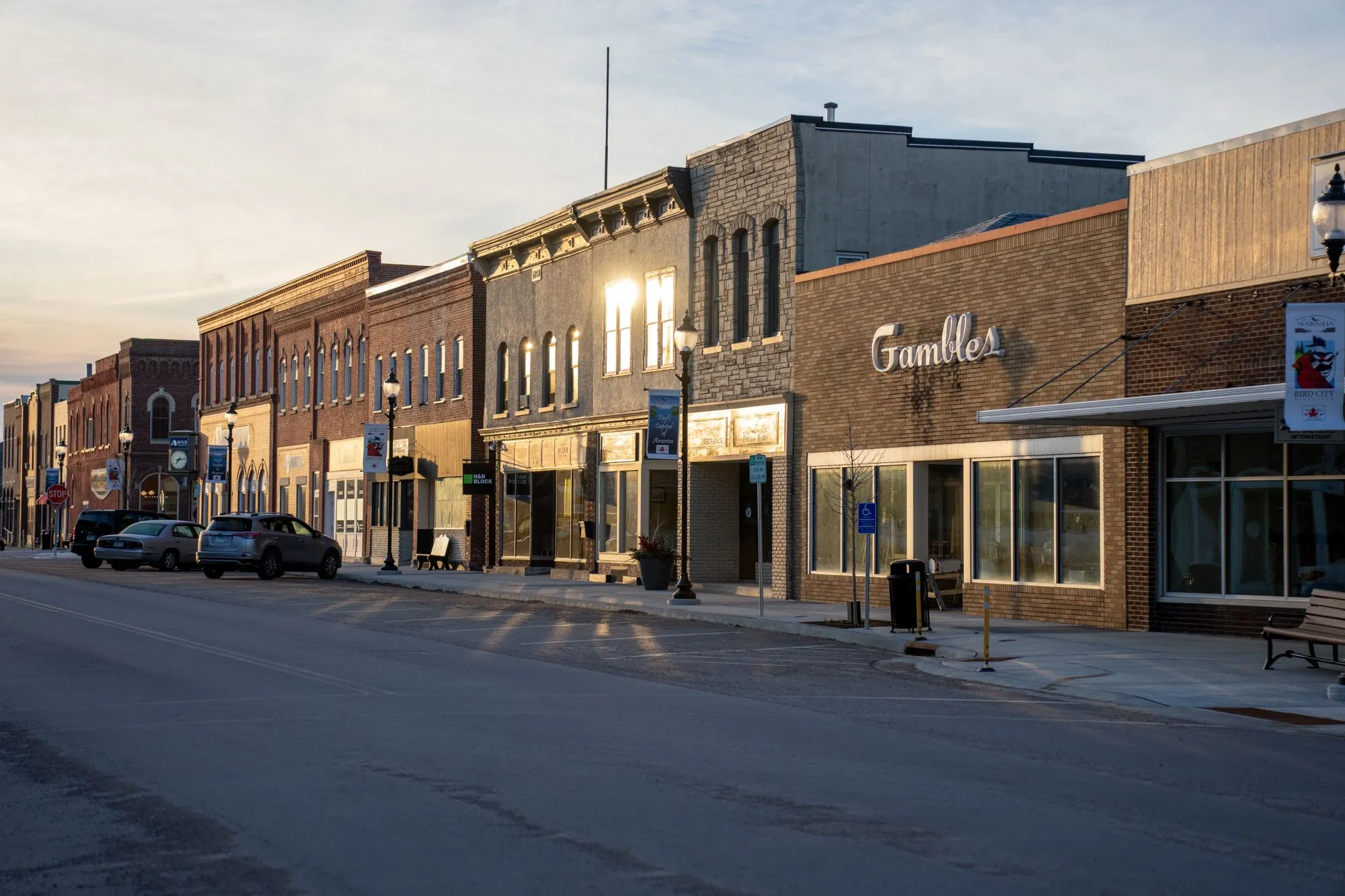 Sunset on a historic main street of brick storefronts.