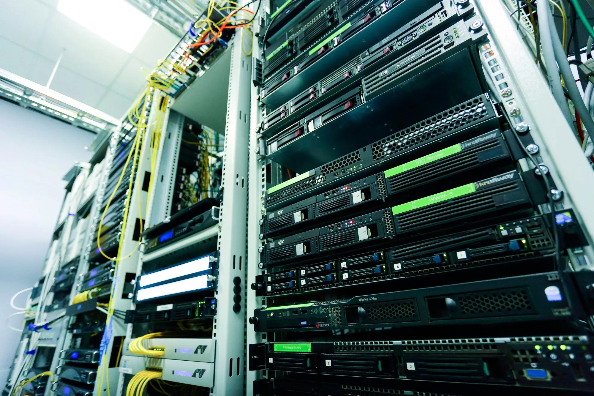 Network servers mounted in an enclosure inside a data room.